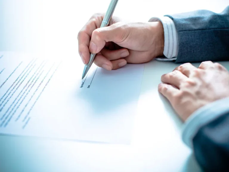 Man in suit signing agreement