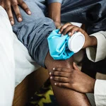 Multiple people to attend someone's arm, holding an ice pack on the elbow