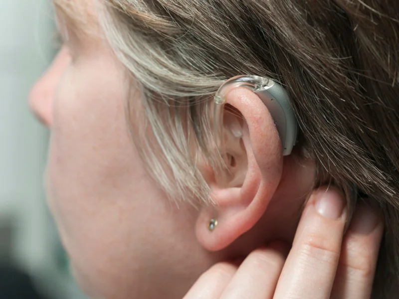 Person's ear with hearing aid
