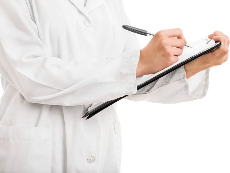 Doctor writing on a clipboard