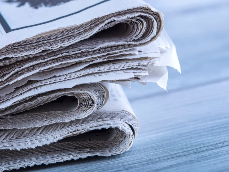 pile of 3 newspapers