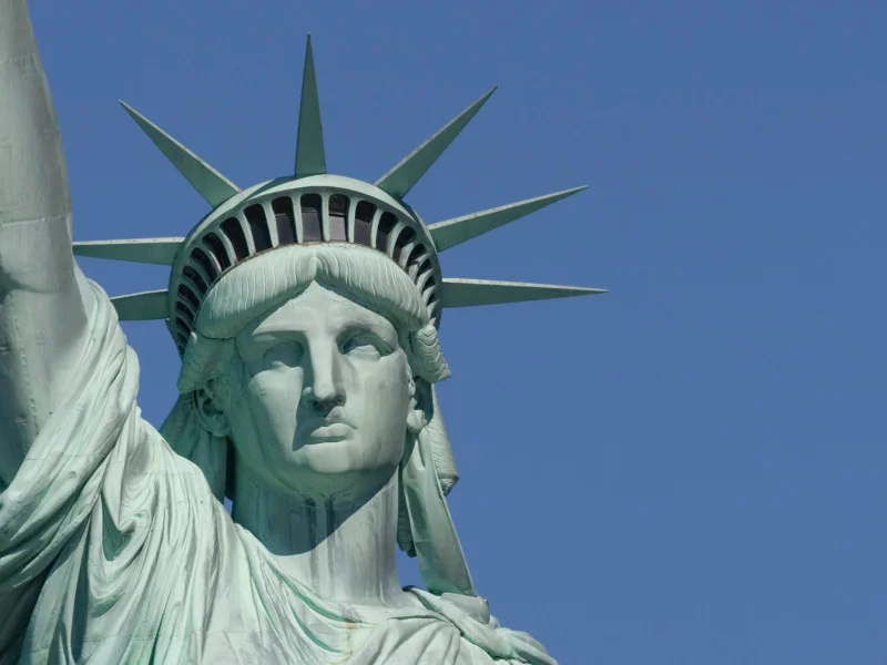 Face of Statue of Liberty with a blue sky in the background