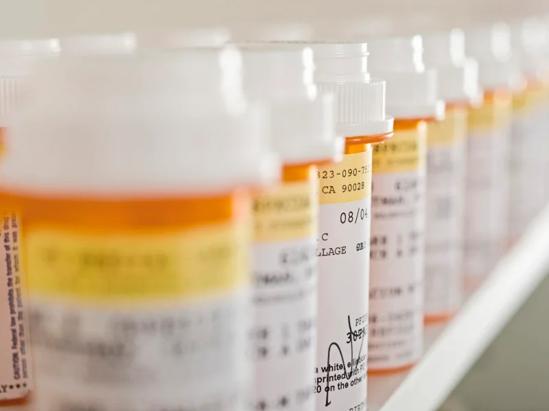 A line of many prescription bottles